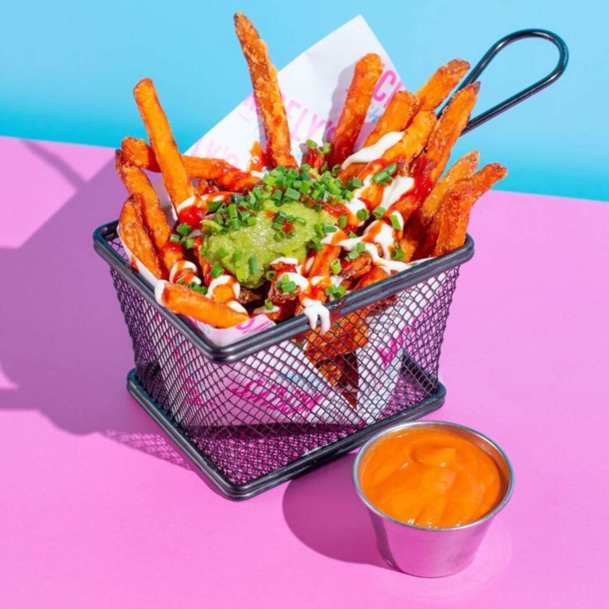 Fish and chips wrapped in greaseproof custom-printed paper with logo.