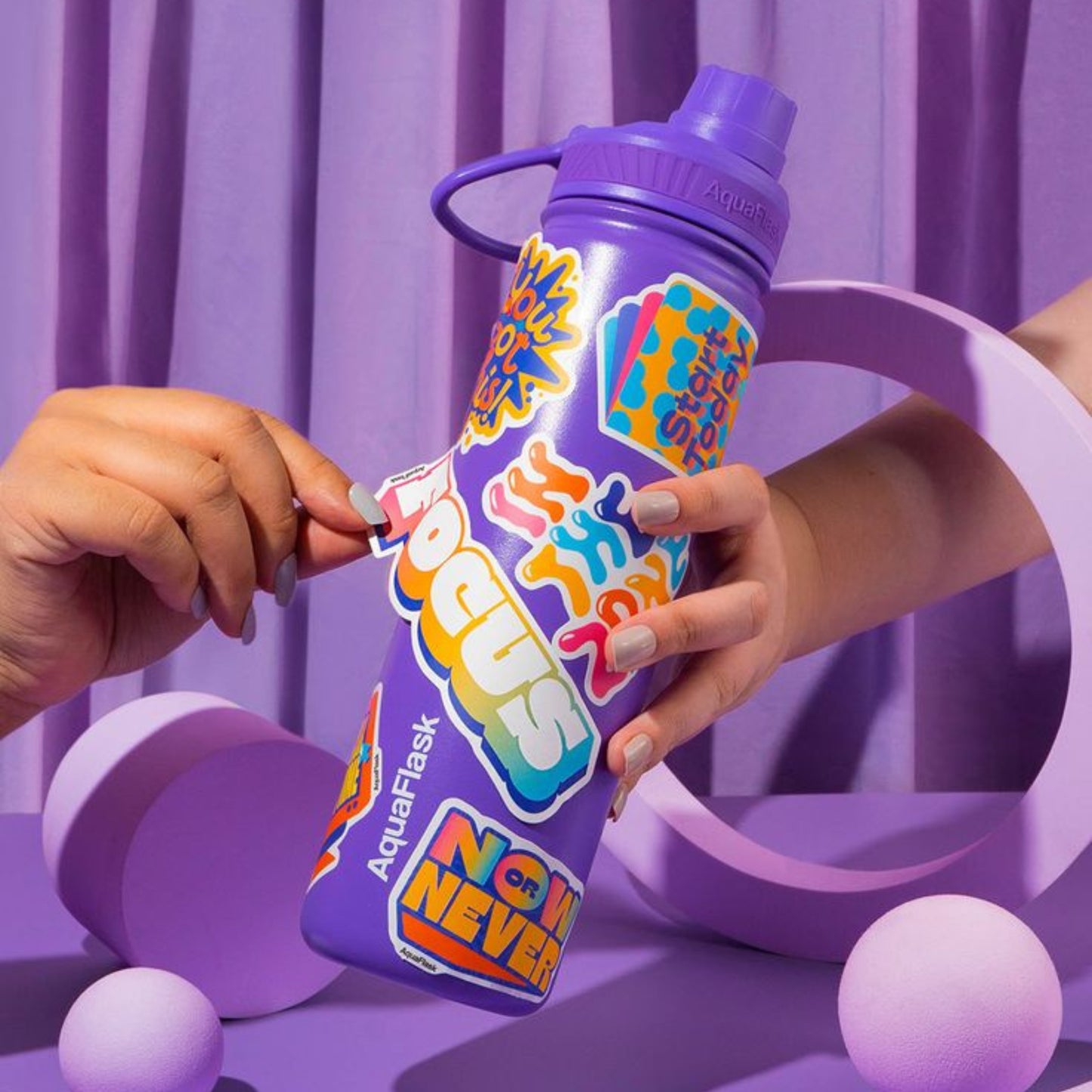 Waterproof stickers applied to a water bottle, showcasing their durability and resistance to water exposure