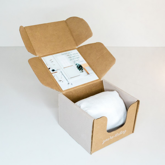 Monthly candle box packaging with minimalist design and logo.