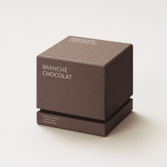 Custom printed two-piece candle packaging with gold foil logo.